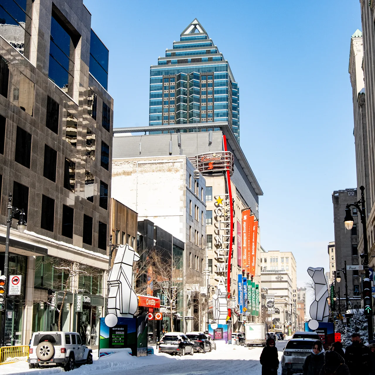 A busy city street beneath a blue sky.